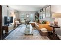 Bright and airy living room with a leather couch, patterned rug, and decorative accents at 5 Newport Nw Pl, Atlanta, GA 30318