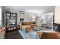 Inviting living room with a comfortable leather sectional, stylish decor, and hardwood floors at 5 Newport Nw Pl, Atlanta, GA 30318