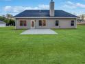 View of the home's backyard showing a concrete patio, green lawn, and siding at 5291 Tuscany Dr, Douglasville, GA 30135