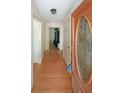 Inviting hallway with hardwood floors and decorative front door, offering a warm welcome at 6835 Castleton Dr, Sandy Springs, GA 30328