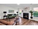Bright and spacious living room boasts a fireplace, stylish furniture, and large windows for ample natural light at 1172 Rockmart Nw Cir, Kennesaw, GA 30144
