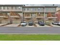Townhome rear view with garage and balconies; parking for multiple vehicles visible at 7850 Willoughby Ct, Alpharetta, GA 30005
