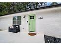 Charming front entrance featuring a light green door, a black bench, and modern house number at 101 Stroud Se Dr, Mableton, GA 30126