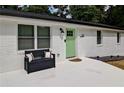 Inviting front porch with a comfortable bench, a light green door, and elegant black hardware at 101 Stroud Se Dr, Mableton, GA 30126