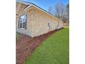 Brick exterior and green lawn showcasing the side view of the house at 5301 Tuscany Dr, Douglasville, GA 30135