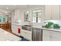 Updated kitchen with white cabinetry, stainless steel appliances, granite counters, and a large sink at 1590 Johnson Ne Rd, Atlanta, GA 30306