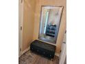 Cozy foyer with a tufted ottoman, decorative mirror, and modern accessories at 2118 Burns View Ln, Lawrenceville, GA 30044