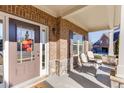Inviting front porch with decorative chairs, stone accents, and a stylish front door at 2225 Independence Ln, Buford, GA 30519