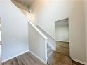 Open staircase with carpeted steps, white risers and white banister, leading to the second floor at 4923 Grizzly Ct, Douglasville, GA 30135