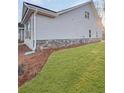 A home with grey siding, brick accents, and a well manicured lawn at 5331 Tuscany Dr, Douglasville, GA 30135