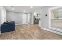 Open-concept living area with wood floors leading to a modern kitchen and white trim at 581 Taylor Se Dr, Smyrna, GA 30080