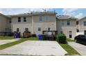 A townhouse featuring a backyard with private parking spots, deck, and beige siding at 162 Odyssey Turn, Conyers, GA 30012