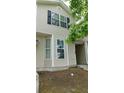 Front view of two-story town house, with neutral siding and black shutters at 162 Odyssey Turn, Conyers, GA 30012
