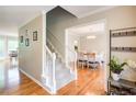 Elegant foyer featuring hardwood floors, a staircase, and an archway leading to the dining room at 1812 Riverton Dr, Suwanee, GA 30024