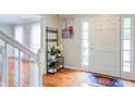 Inviting foyer with hardwood floors, a white front door and staircase, and decor at 1812 Riverton Dr, Suwanee, GA 30024