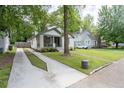 Quaint brick home with a long driveway and a lush green lawn at 2284 Dauphine St, East Point, GA 30344