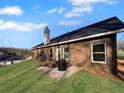 Back exterior view of a brick home with a small patio and large yard space at 5321 Tuscany Dr, Douglasville, GA 30135