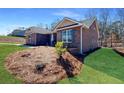 An angle view of a well maintained single story brick home with green lawn at 5321 Tuscany Dr, Douglasville, GA 30135
