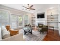 Bright living room features fireplace, built-in shelves, ceiling fan, and French doors at 75 High Top Ln, Atlanta, GA 30328