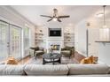 Cozy living room with fireplace, built-in shelving, ceiling fan, and lots of light at 75 High Top Ln, Atlanta, GA 30328