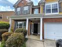 Welcoming front entrance with a covered porch, white pillars, and a view of the elegant front door at 1117 Balvaird Dr, Lawrenceville, GA 30045