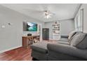 Spacious living room with hardwood floors, a cozy sectional sofa, and modern entertainment setup at 118 Greenwood St, Fairburn, GA 30213