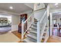 Elegant staircase with white railing and hardwood floors leading to the upper level at 375 Spindle Ct, Sandy Springs, GA 30350