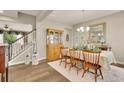 Traditional dining room features a wooden hutch, elegant table setting, and staircase in the background at 186 Greenbrier Way, Canton, GA 30114