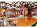 Cozy library with wood paneling, coffered ceiling, and extensive bookshelves at 199 14Th Ne St # 710, Atlanta, GA 30309
