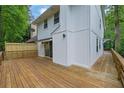 A spacious wooden deck offers ample outdoor entertaining space with a sliding glass door to enter the home at 2551 Park Se Rd, Smyrna, GA 30080