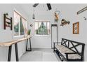 Sun-drenched entryway with bench seating, neutral walls, and ample decor at 428 Tibbetts Se St, Marietta, GA 30060