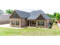 Beautiful brick home with a covered porch and well-maintained landscaping at 953 Auburn Rd, Dacula, GA 30019