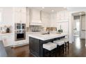 Spacious kitchen with a large center island, stainless steel appliances, and custom cabinetry at 1085 Celebration Dr, Roswell, GA 30076