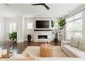 Bright living room with a modern fireplace, large windows, and stylish decor at 1085 Celebration Dr, Roswell, GA 30076