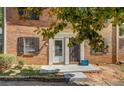 Charming brick home showcasing a well-kept lawn with landscaped beds and a welcoming front entrance at 115 Plantation Dr, Clarkston, GA 30021