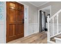 Inviting foyer with hardwood floors, white wainscoting, and a decorative glass front door at 4524 Shumart Dr, Snellville, GA 30039