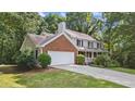 Lovely home featuring a brick-accented facade, a two-car garage, and a welcoming front porch at 4524 Shumart Dr, Snellville, GA 30039