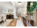 Elegant foyer with hardwood floors, decorative console table, staircase, and abundant natural light at 4674 Lakeway Pl, Alpharetta, GA 30005