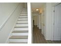 Bright hallway with wood flooring and a staircase leading to the upper level at 1812 Ashborough Se Cir # C, Marietta, GA 30067