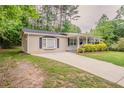 Attractive home with a cozy, covered porch and a well-kept yard for outdoor enjoyment at 2212 Chestnut Log Loop, Lithia Springs, GA 30122