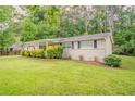 Inviting home exterior showcasing a lush green lawn and well-maintained landscaping at 2212 Chestnut Log Loop, Lithia Springs, GA 30122