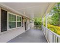 A cozy front porch offers an inviting outdoor space to relax at 2212 Chestnut Log Loop, Lithia Springs, GA 30122