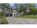 Lovely two-story house with a driveway, a black mailbox and mature trees in the background at 4978 Thornwood Nw Cv, Acworth, GA 30102