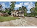 Lovely home with landscaped grounds and an extended driveway leading to a two-car garage at 509 Orchards Walk, Stone Mountain, GA 30087
