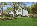 Beautiful home exterior featuring lush green grass, lovely landscaping and mature shade trees at 230 Bluff Oak Dr, Roswell, GA 30076