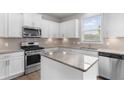 Modern kitchen featuring stainless steel appliances, granite countertops, and white cabinets at 4238 Linworth Blvd, Austell, GA 30106