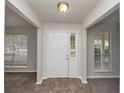 Bright foyer features neutral walls, tile flooring, and a clear view of the living spaces at 565 Lake Joyce Ln, Fairburn, GA 30213