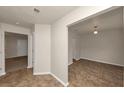 Hallway with tile flooring leading to multiple rooms, complemented by neutral wall colors at 565 Lake Joyce Ln, Fairburn, GA 30213