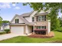 Well-kept home with a manicured lawn, complemented by classic brick accents, siding and an attached garage at 10204 Deep Creek Pl, Union City, GA 30291