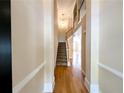 Bright foyer features hardwood floors, staircase, and a view into the living spaces at 2656 Gadsen Walk, Duluth, GA 30097